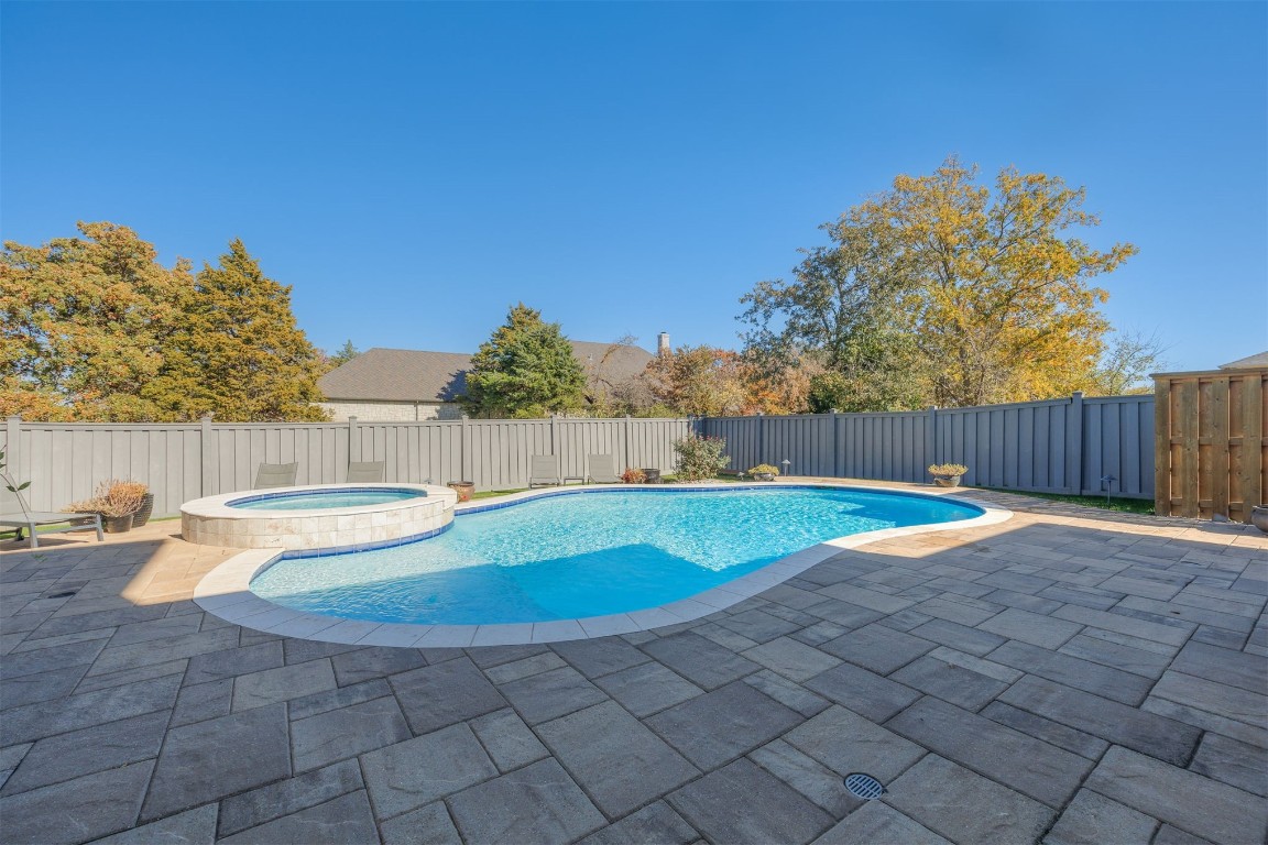 6332 Wentworth Drive, Edmond, OK 73025 view of pool featuring a patio and an in ground hot tub