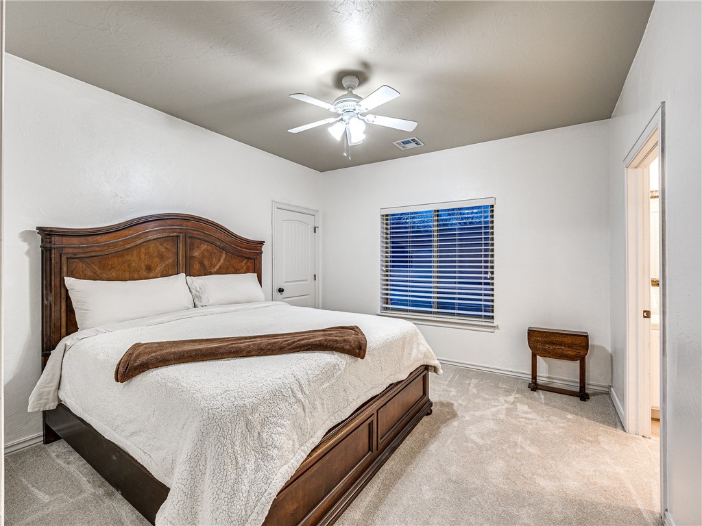 3624 Winding Lake Circle, Arcadia, OK 73007 bedroom featuring ceiling fan and light carpet