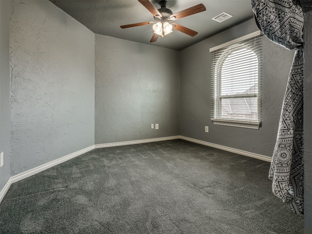 1517 SW 132nd Street, Oklahoma City, OK 73170 unfurnished room featuring ceiling fan and dark carpet