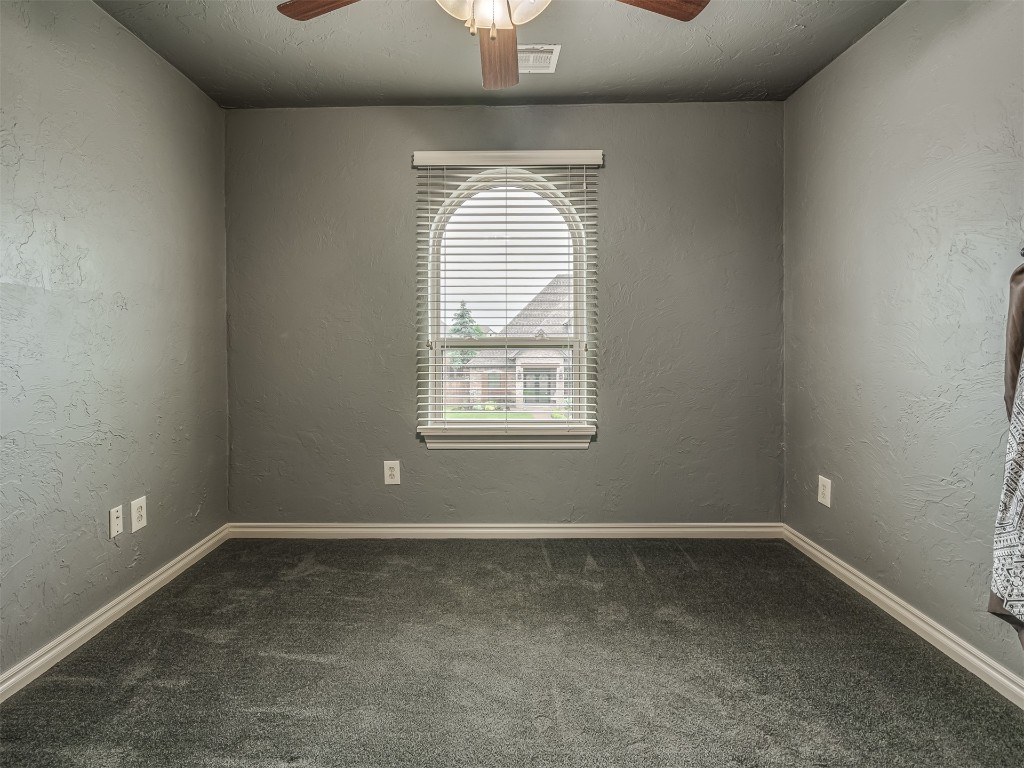 1517 SW 132nd Street, Oklahoma City, OK 73170 empty room featuring ceiling fan and dark carpet