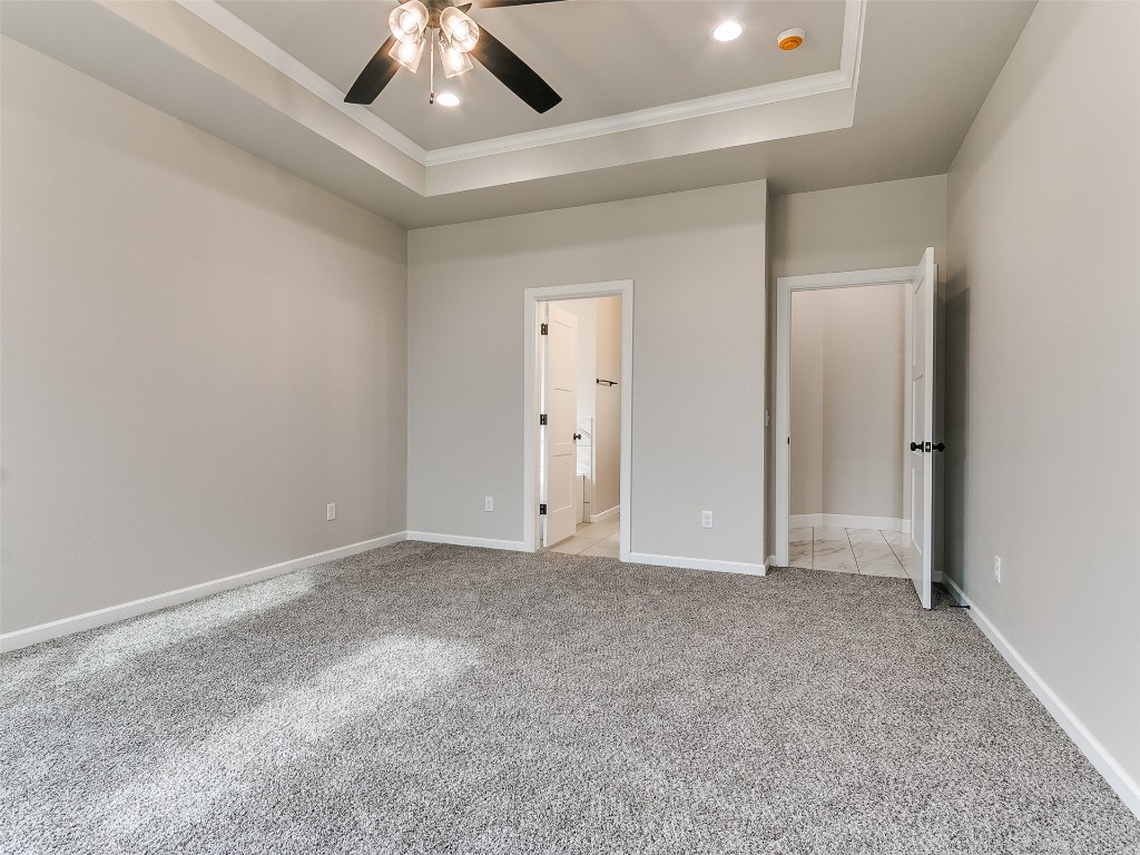 500 Carlow Way, Yukon, OK 73099 unfurnished bedroom featuring concrete flooring, a closet, and ceiling fan