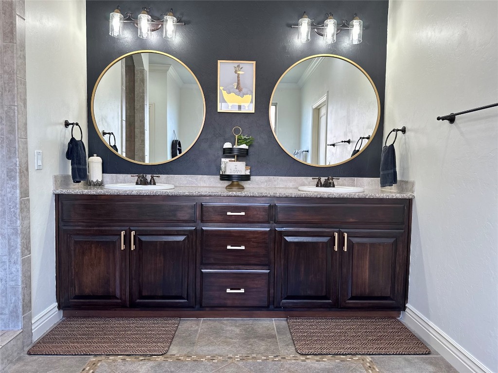 715 NW Elm Street, Piedmont, OK 73078 bathroom with plus walk in shower, vanity, tile floors, and ornamental molding