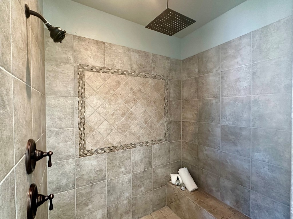715 NW Elm Street, Piedmont, OK 73078 bathroom with a wealth of natural light, a relaxing tiled bath, and tile floors