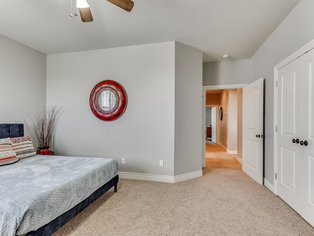 715 NW Elm Street, Piedmont, OK 73078 bedroom featuring ceiling fan and carpet floors