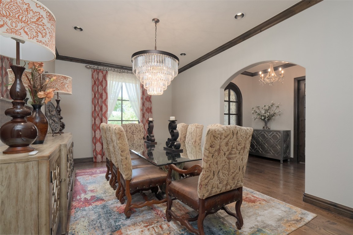 1200 Settlers Drive, Edmond, OK 73034 dining area with ornamental molding, dark hardwood / wood-style flooring, and a notable chandelier