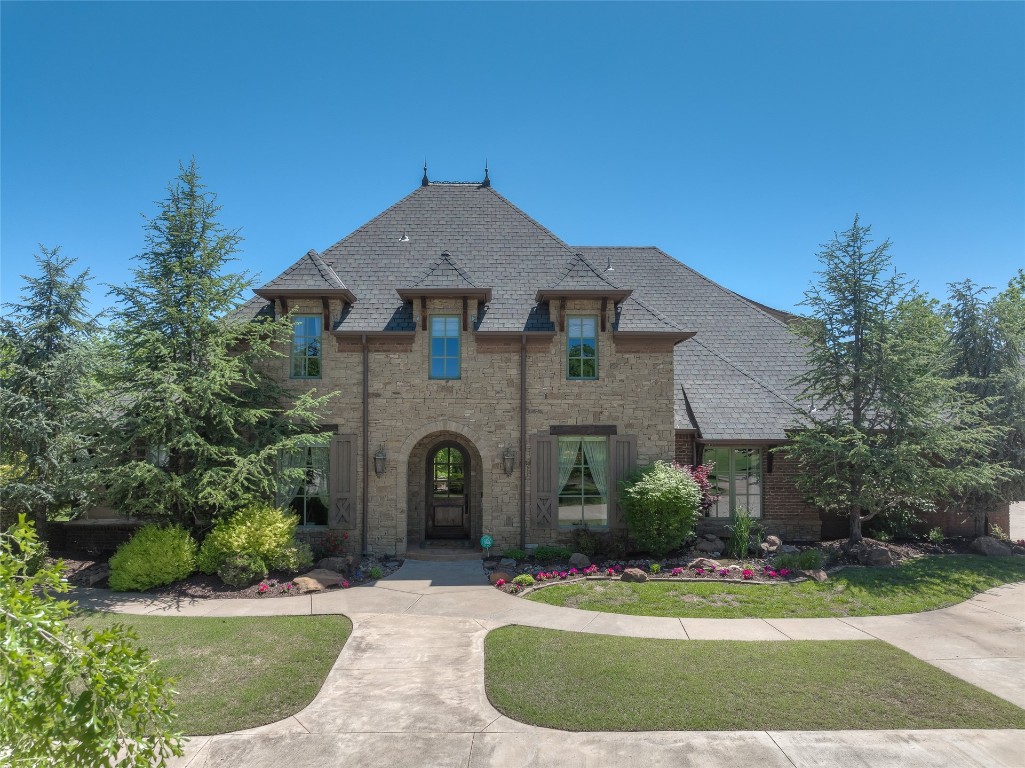1200 Settlers Drive, Edmond, OK 73034 french country inspired facade featuring a front lawn