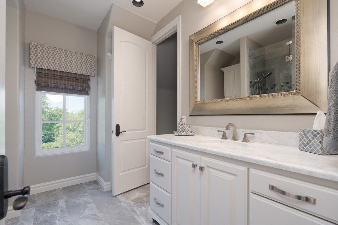 1200 Settlers Drive, Edmond, OK 73034 bathroom with walk in shower, tile floors, and oversized vanity