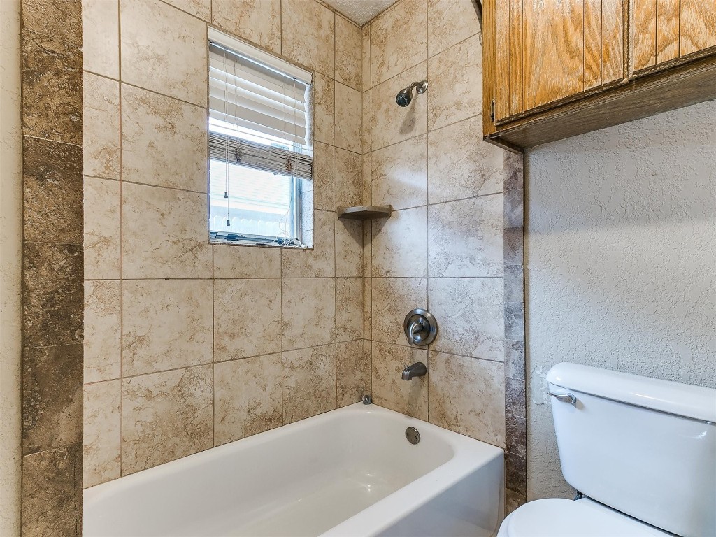 613 Cactus Court, Yukon, OK 73099 bathroom with tiled shower / bath combo and toilet