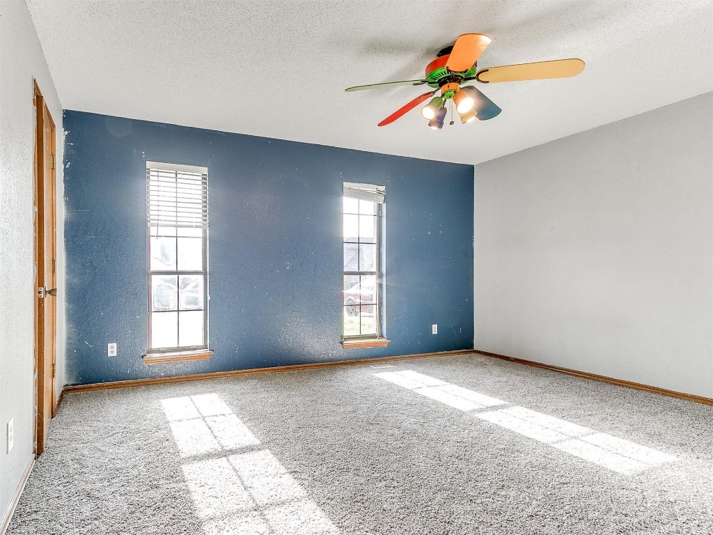 613 Cactus Court, Yukon, OK 73099 carpeted empty room featuring ceiling fan and a textured ceiling