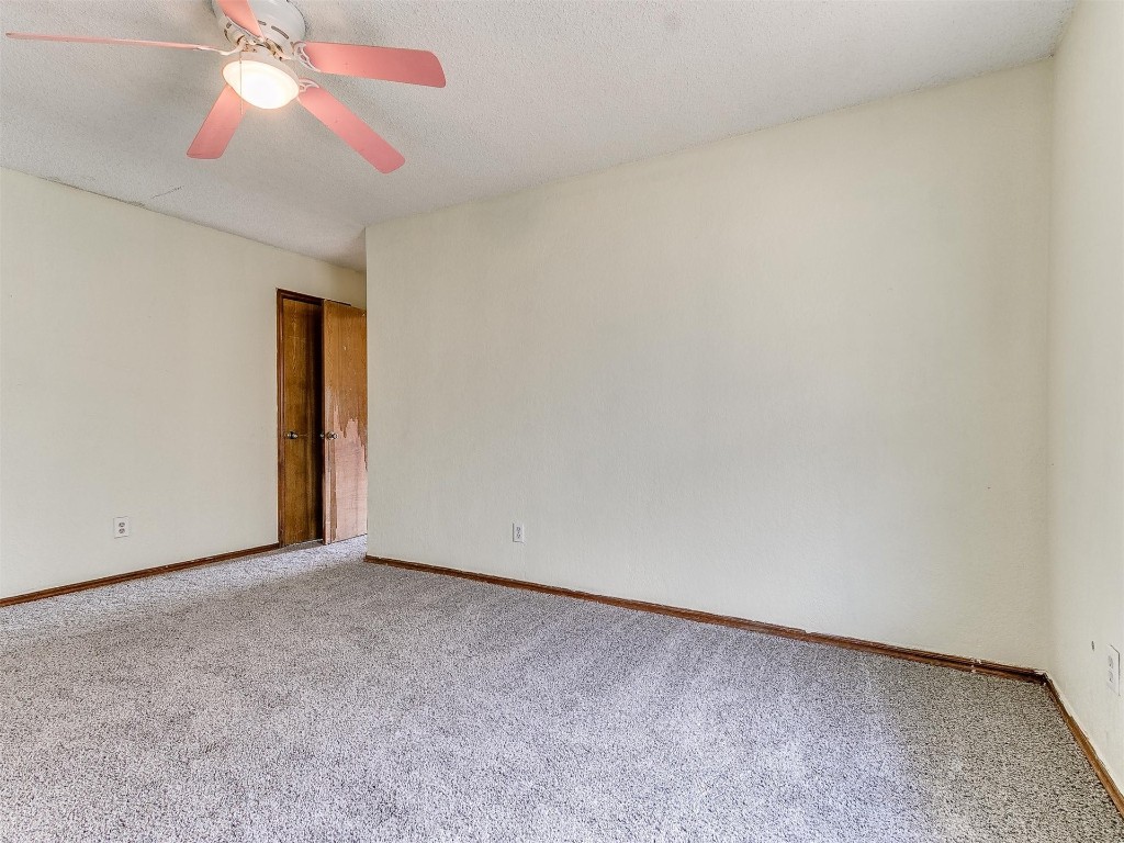 613 Cactus Court, Yukon, OK 73099 carpeted empty room with ceiling fan