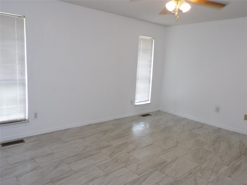 8212 Harvest Hills Road, Oklahoma City, OK 73132 unfurnished room with ceiling fan and light tile floors