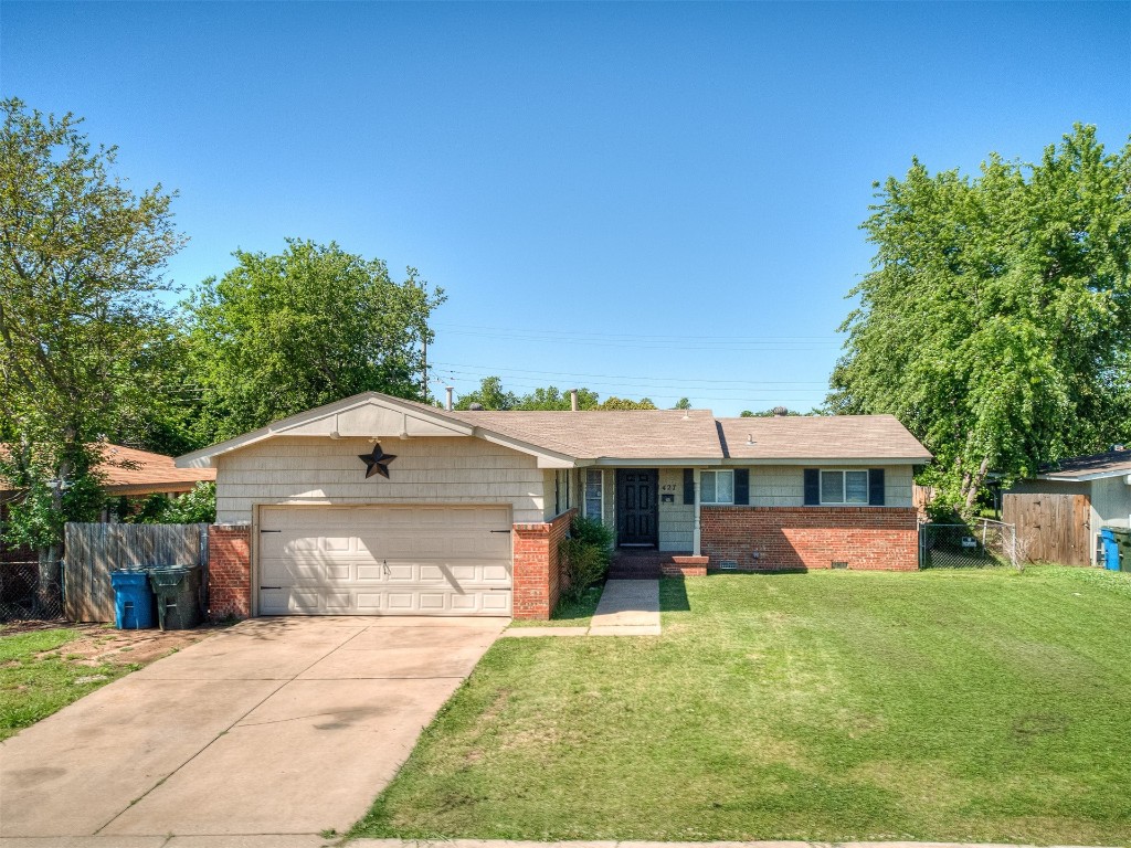 427 W Fairchild Drive, Midwest City, OK 73110 ranch-style home featuring a front yard and a garage