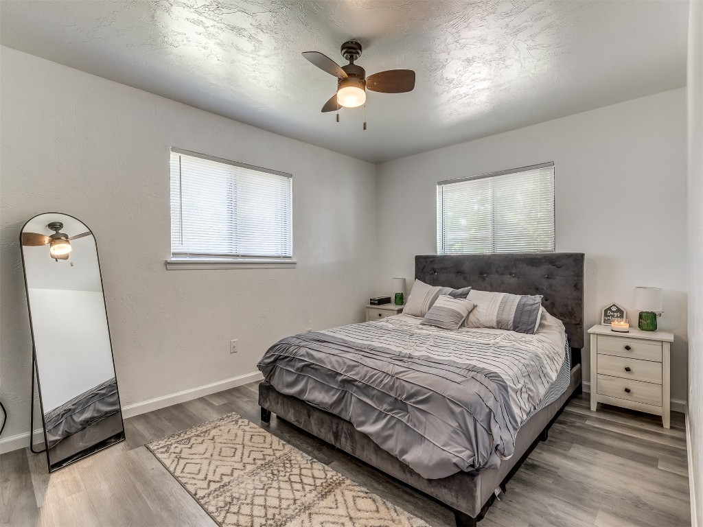 427 W Fairchild Drive, Midwest City, OK 73110 bedroom featuring wood-type flooring and ceiling fan