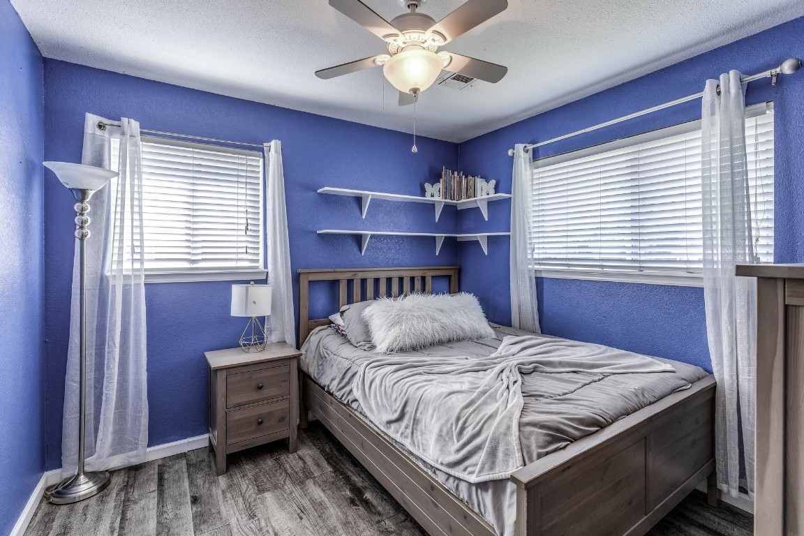 2709 SW 65th Street, Oklahoma City, OK 73159 bedroom featuring multiple windows, ceiling fan, and hardwood / wood-style flooring