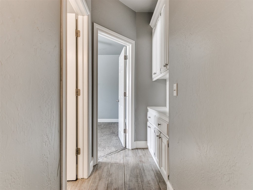 916 Hunters Pointe Road, Edmond, OK 73003 bathroom featuring wood-type flooring and vanity