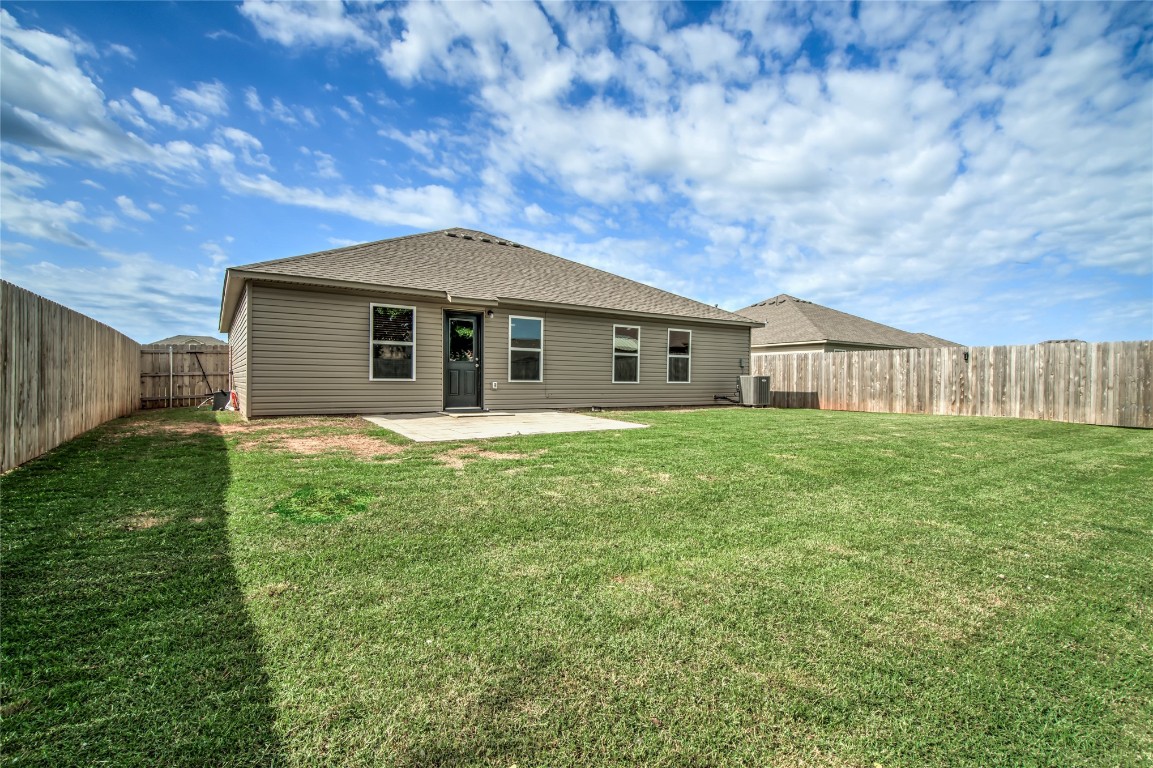 633 W Ava Drive, Mustang, OK 73064 back of property featuring a patio area and a yard