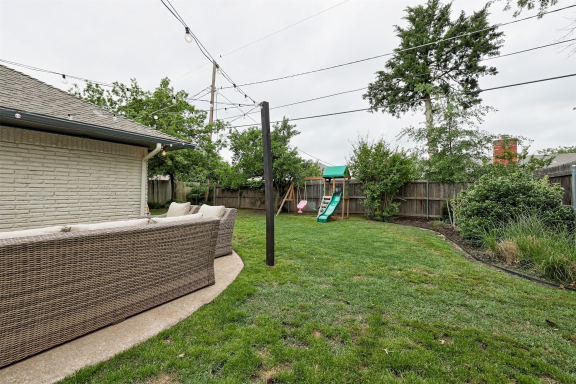 2509 NW 58th Street, Oklahoma City, OK 73112 view of yard featuring a patio and a playground