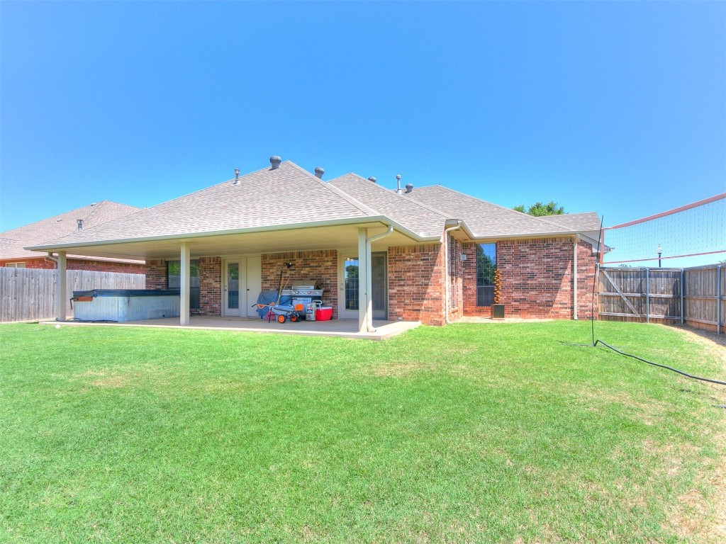 17001 Kemble Lane, Edmond, OK 73012 back of property with a patio and a yard