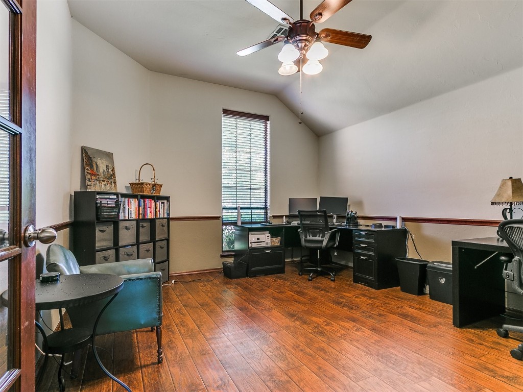 17001 Kemble Lane, Edmond, OK 73012 home office with hardwood / wood-style floors, vaulted ceiling, and ceiling fan