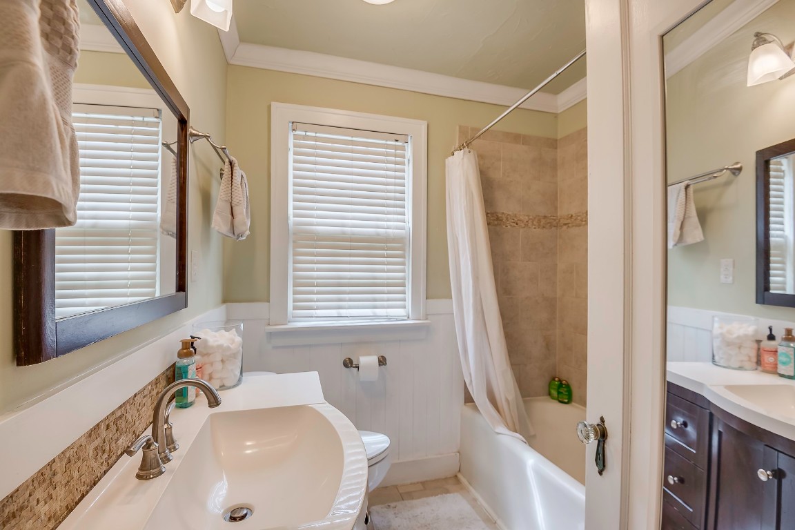 434 NW 35th Street, Oklahoma City, OK 73118 full bathroom with a healthy amount of sunlight, tile floors, vanity, and toilet