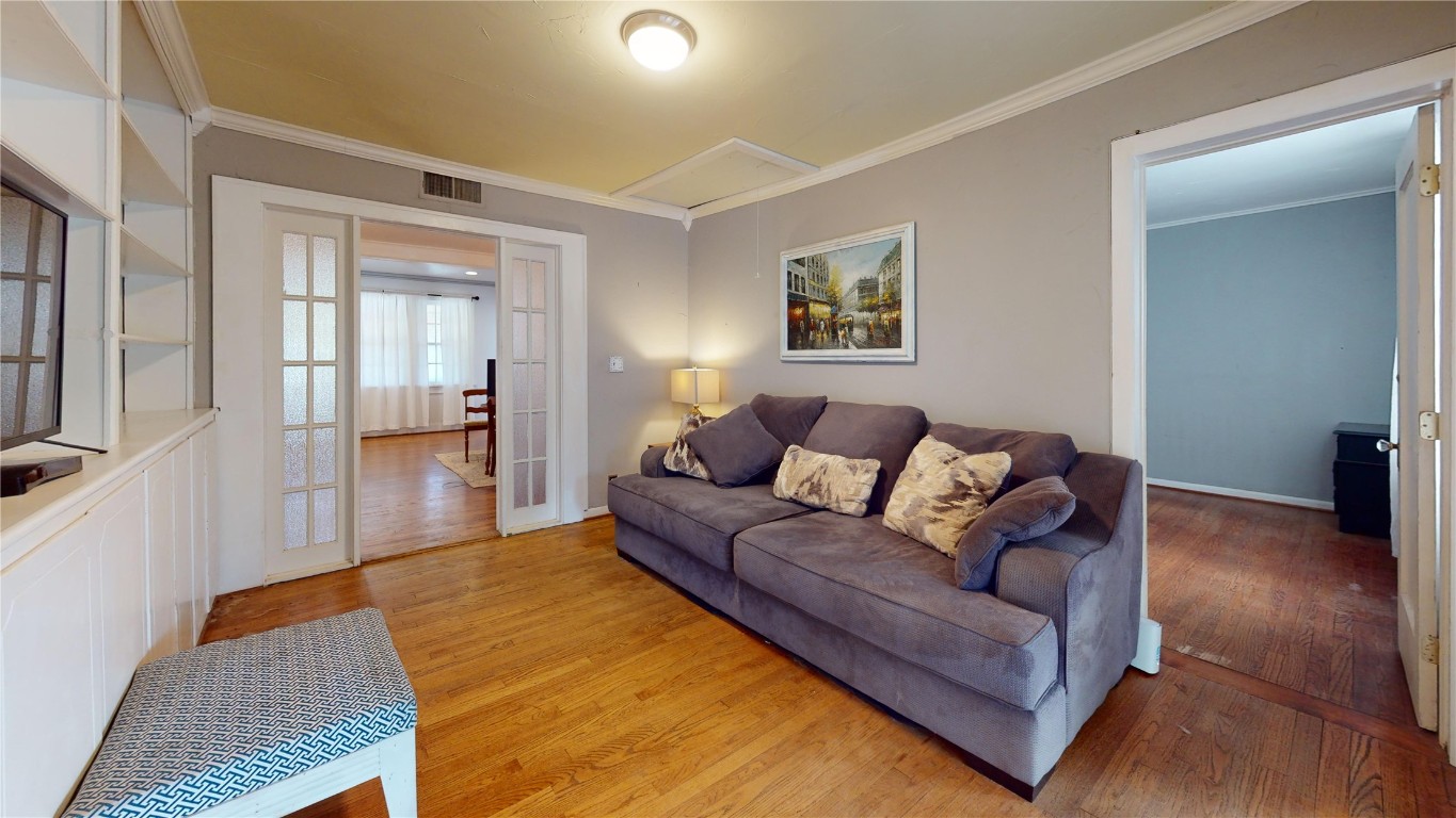 434 NW 35th Street, Oklahoma City, OK 73118 living room with ornamental molding and light hardwood / wood-style flooring