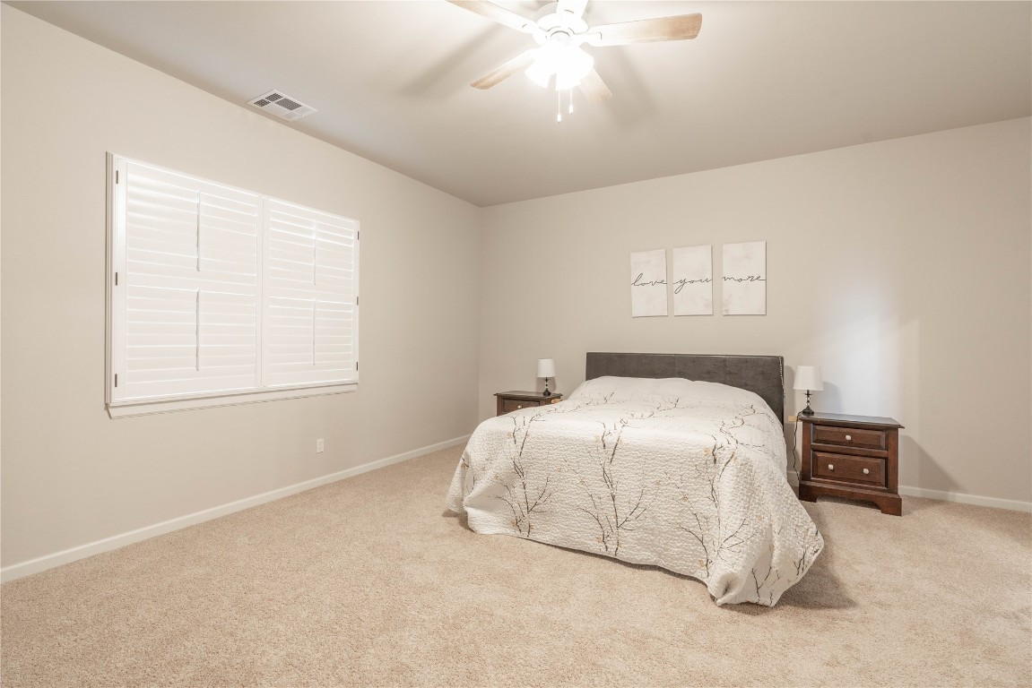 3421 Austrian Pine Lane, Yukon, OK 73099 bedroom featuring ceiling fan and carpet