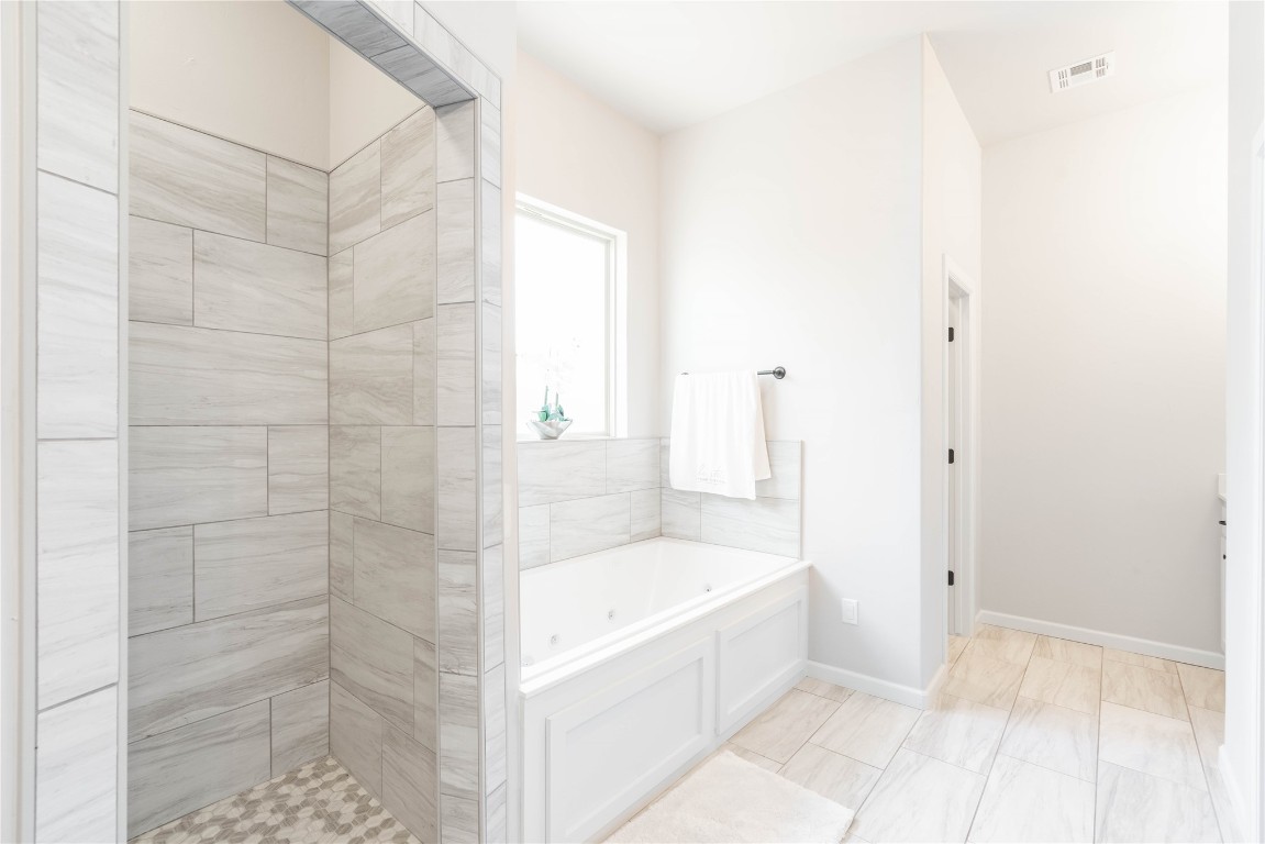 3421 Austrian Pine Lane, Yukon, OK 73099 bathroom with a tile shower