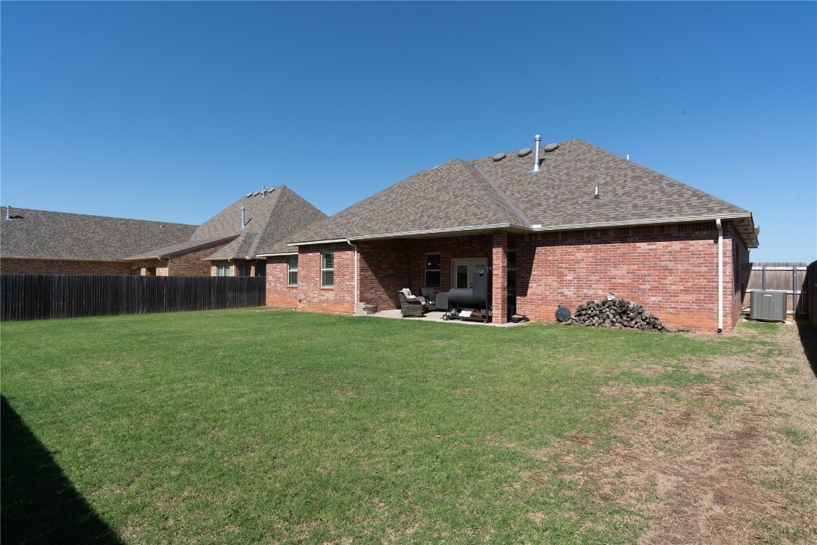 3421 Austrian Pine Lane, Yukon, OK 73099 rear view of property with a yard and a patio