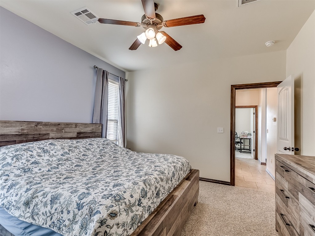 9117 NW 139th Street, Yukon, OK 73099 carpeted bedroom with ceiling fan