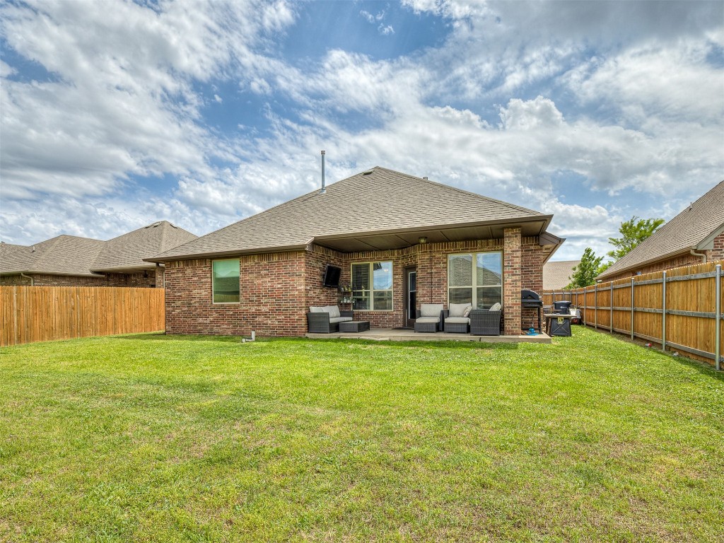 9117 NW 139th Street, Yukon, OK 73099 rear view of property featuring a patio area and a yard
