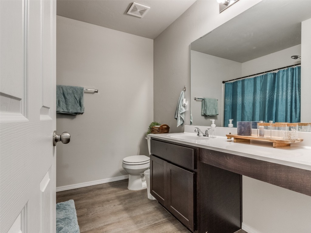 3829 Palio Lane, Oklahoma City, OK 73179 bathroom featuring toilet, vanity, and hardwood / wood-style floors