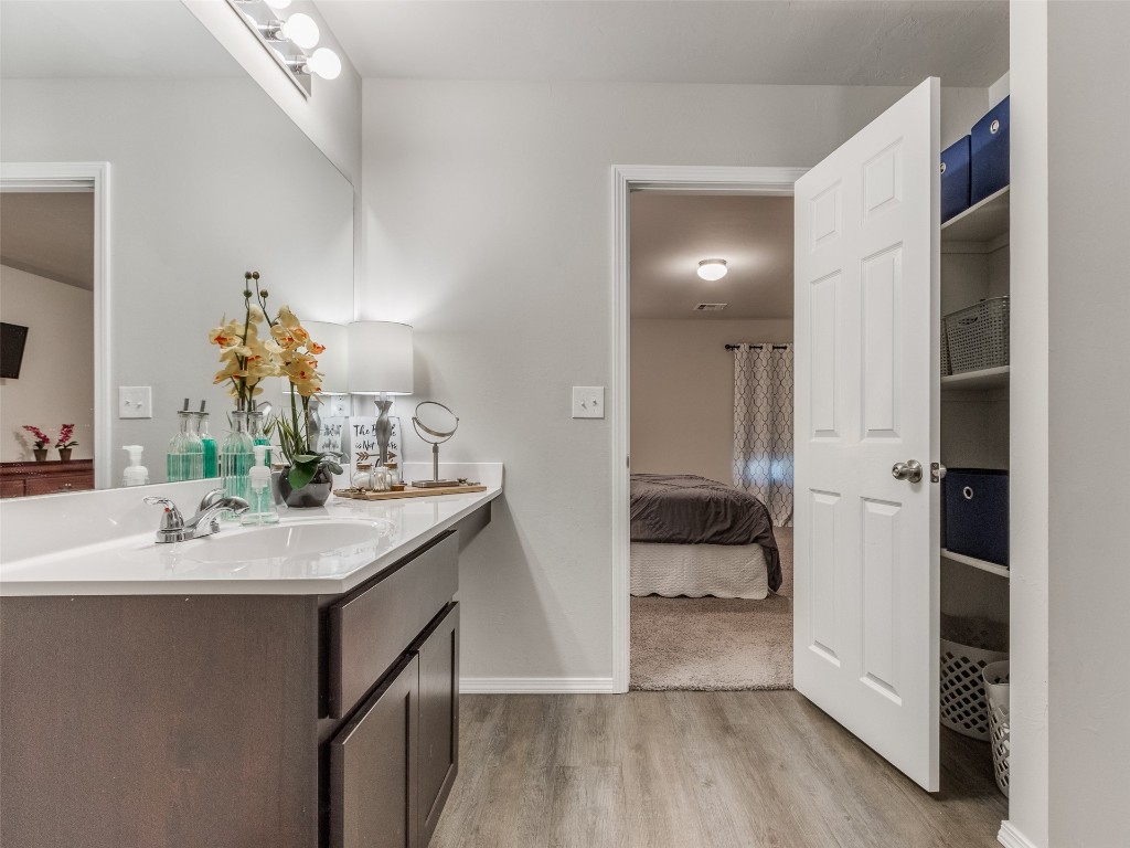 3829 Palio Lane, Oklahoma City, OK 73179 bathroom featuring wood-type flooring and vanity