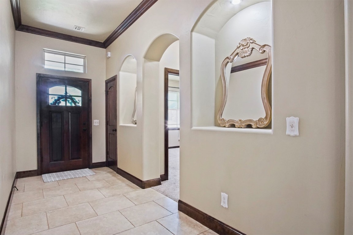 3405 NW 164th Street, Edmond, OK 73013 foyer featuring crown molding and light tile flooring