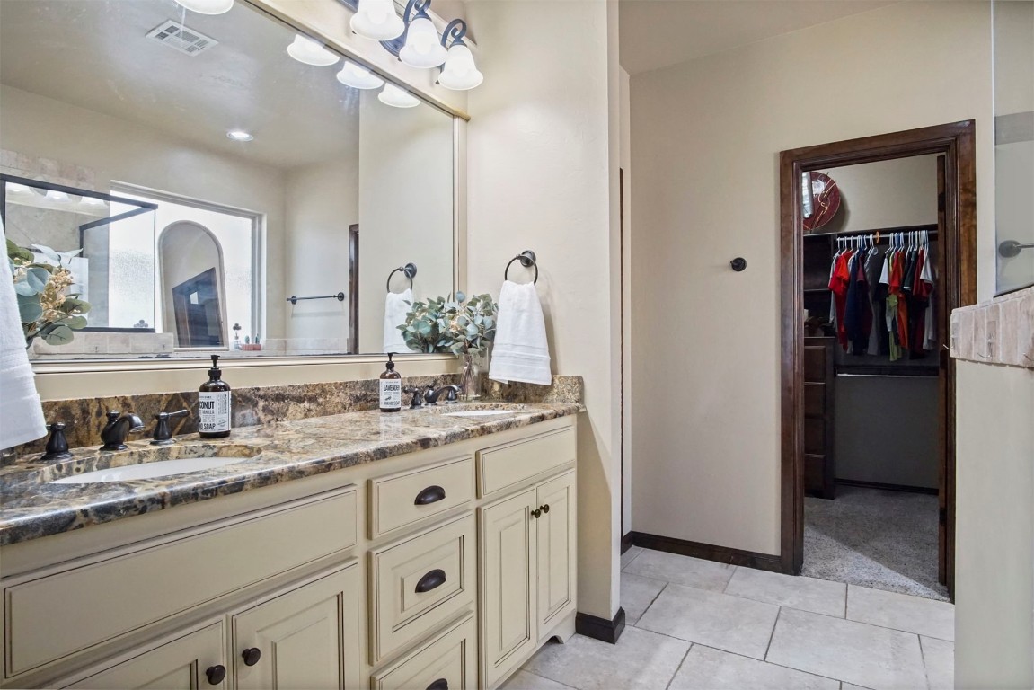 3405 NW 164th Street, Edmond, OK 73013 bathroom with double sink, tile floors, and large vanity