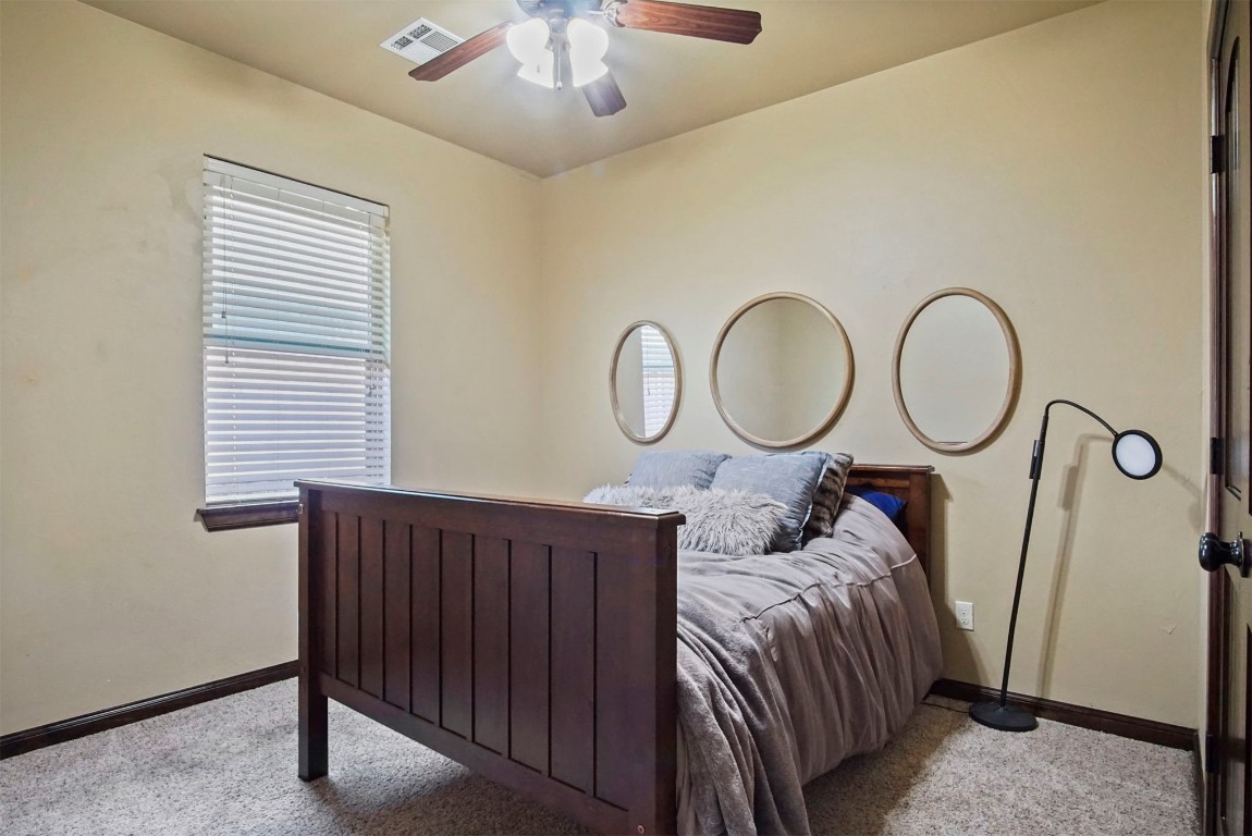3405 NW 164th Street, Edmond, OK 73013 carpeted bedroom featuring ceiling fan