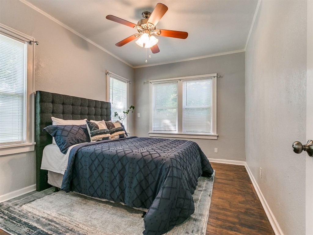2224 N Indiana Avenue, Oklahoma City, OK 73106 bedroom with ornamental molding, dark hardwood / wood-style flooring, and ceiling fan