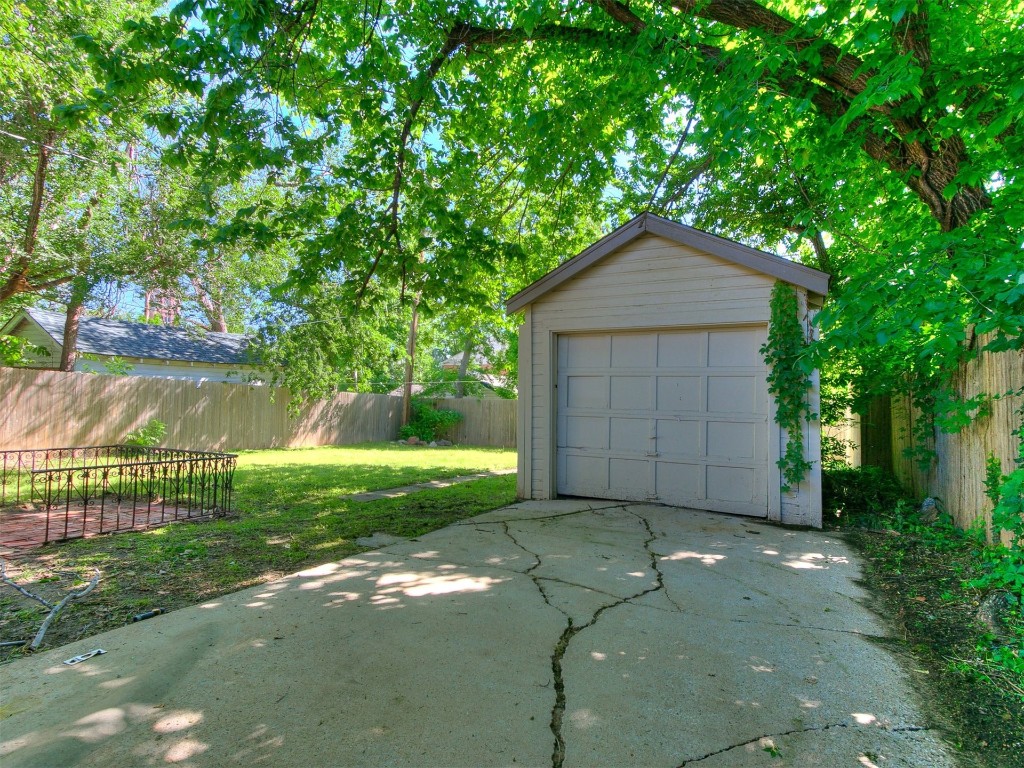 2224 N Indiana Avenue, Oklahoma City, OK 73106 garage featuring a lawn