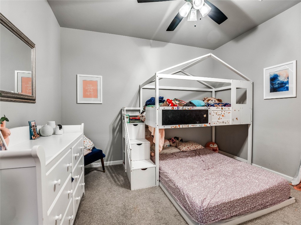 18725 Big Cedar Way, Edmond, OK 73012 carpeted bedroom with ceiling fan