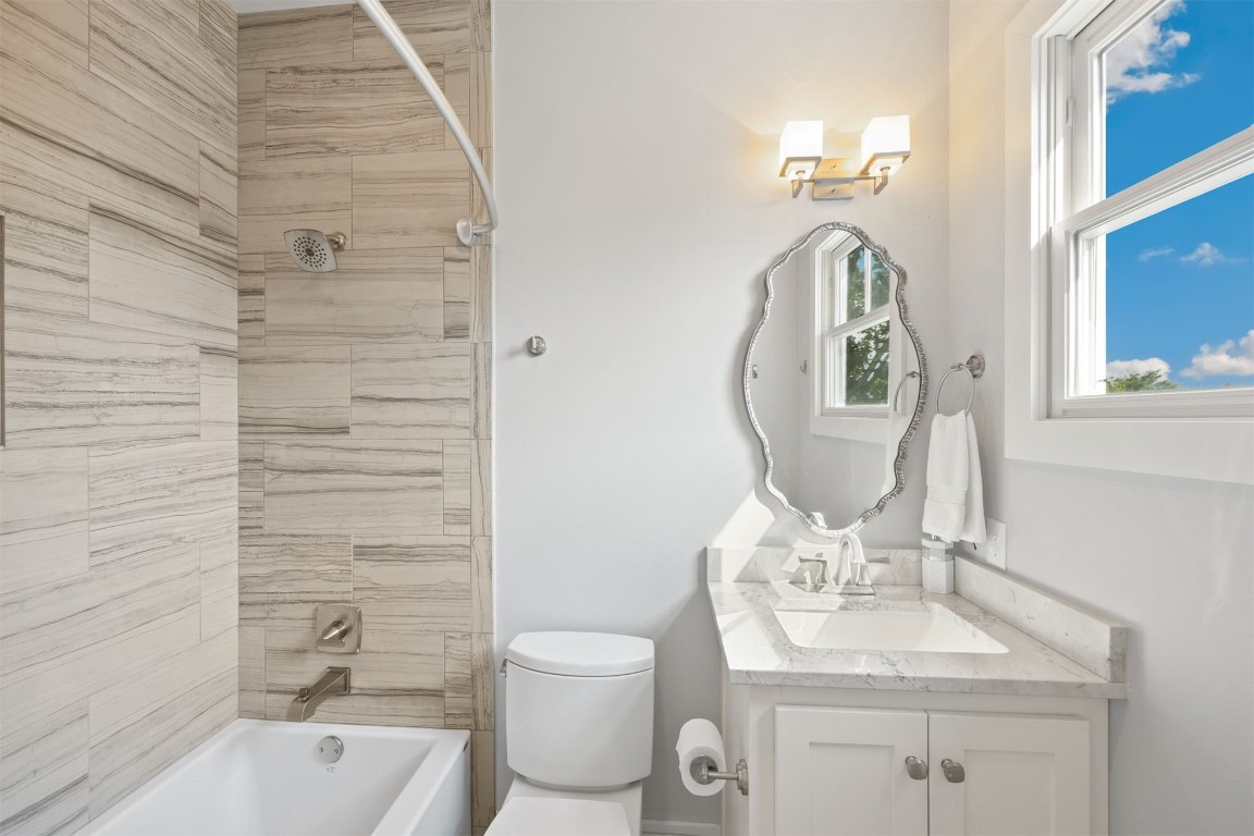 53 Boardwalk Street, Carlton Landing, OK 74432 full bathroom with tiled shower / bath combo, vanity, and toilet