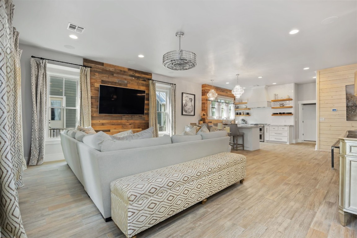 53 Boardwalk Street, Carlton Landing, OK 74432 living room featuring wood walls and light wood-type flooring