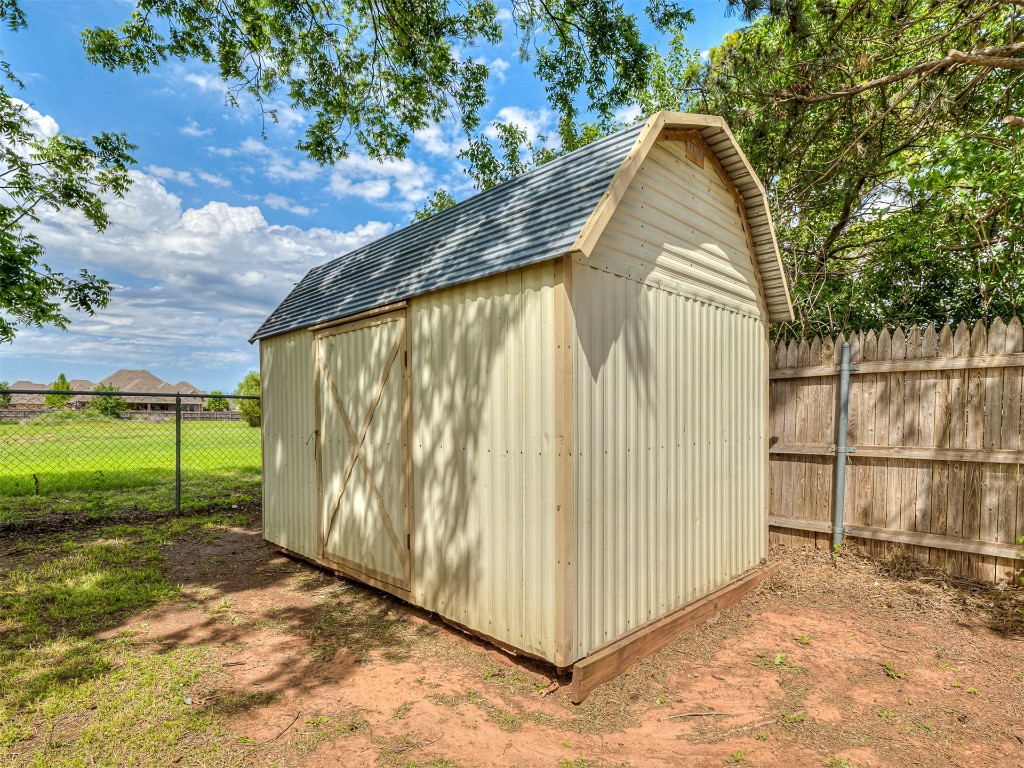 935 W Ridgehaven Way, Mustang, OK 73064 view of shed / structure with a lawn