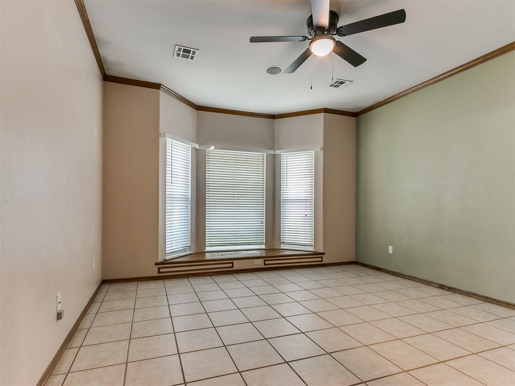 1400 NW 9th Street, Moore, OK 73170 spare room with ornamental molding, ceiling fan, and light tile floors