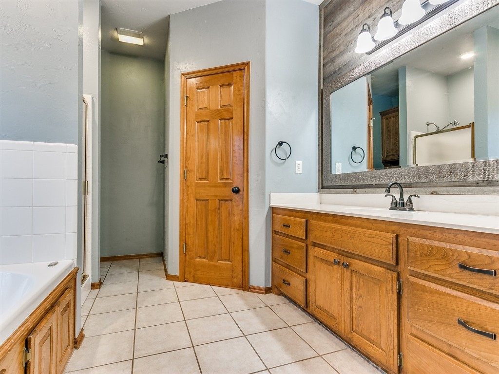 1400 NW 9th Street, Moore, OK 73170 bathroom featuring a tub, vanity, and tile flooring