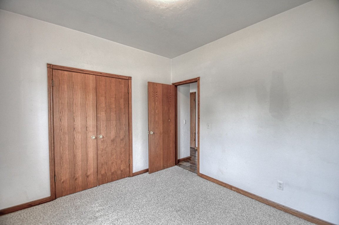 1725 Ryan Way, Edmond, OK 73003 unfurnished bedroom featuring a closet and carpet floors