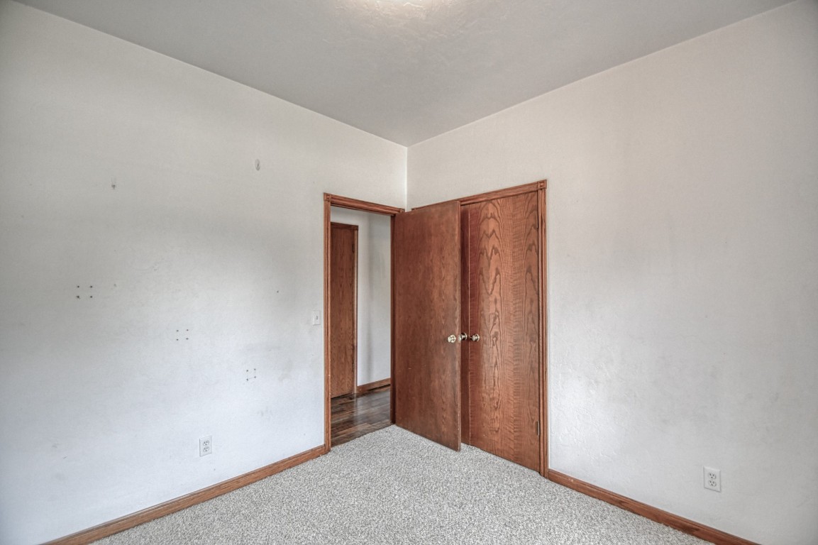 1725 Ryan Way, Edmond, OK 73003 unfurnished bedroom with carpet floors