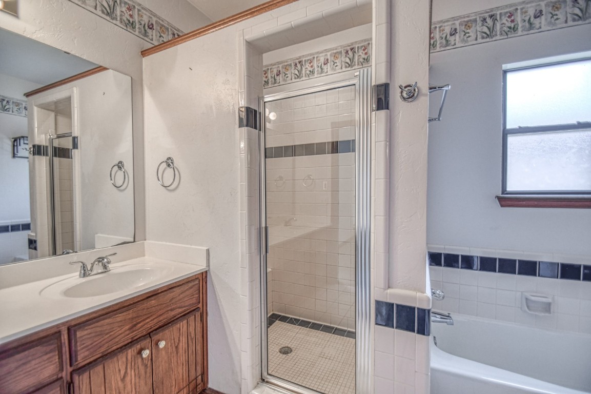 1725 Ryan Way, Edmond, OK 73003 bathroom with independent shower and bath and vanity