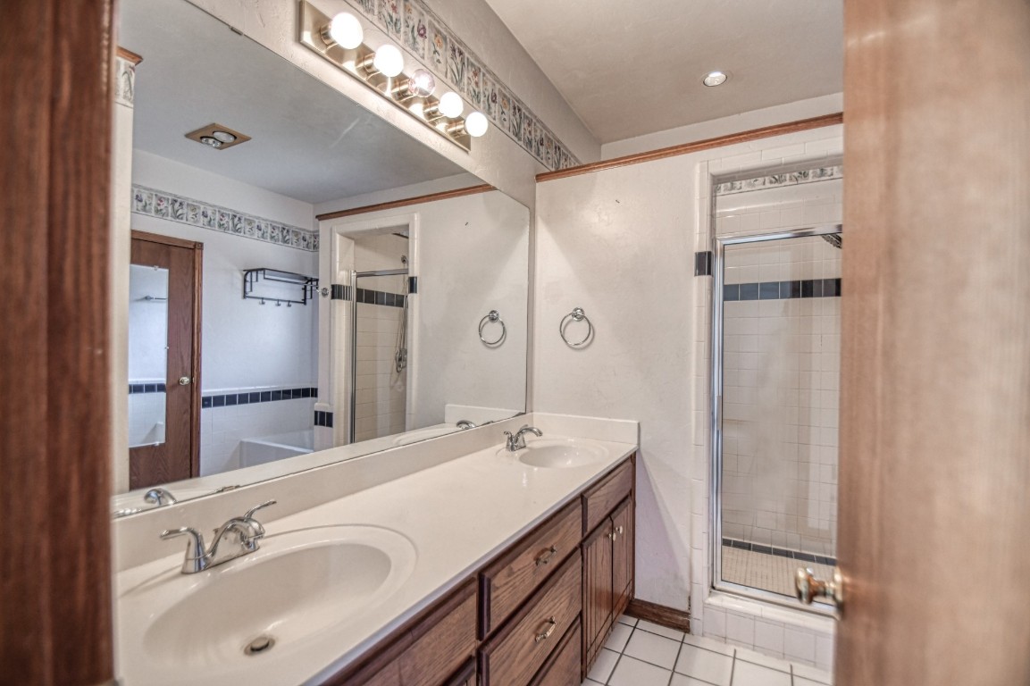 1725 Ryan Way, Edmond, OK 73003 bathroom with dual sinks, independent shower and bath, large vanity, and tile floors