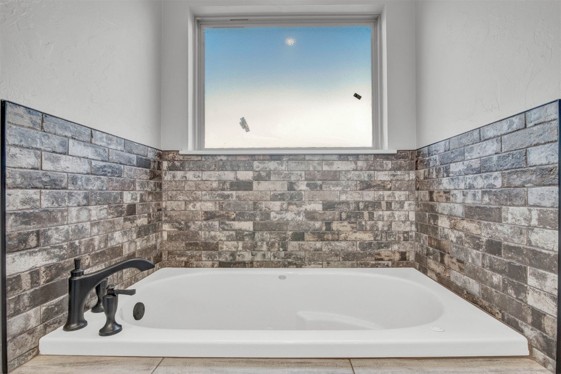 2105 Valley View, Weatherford, OK 73096 bathroom featuring a bath to relax in