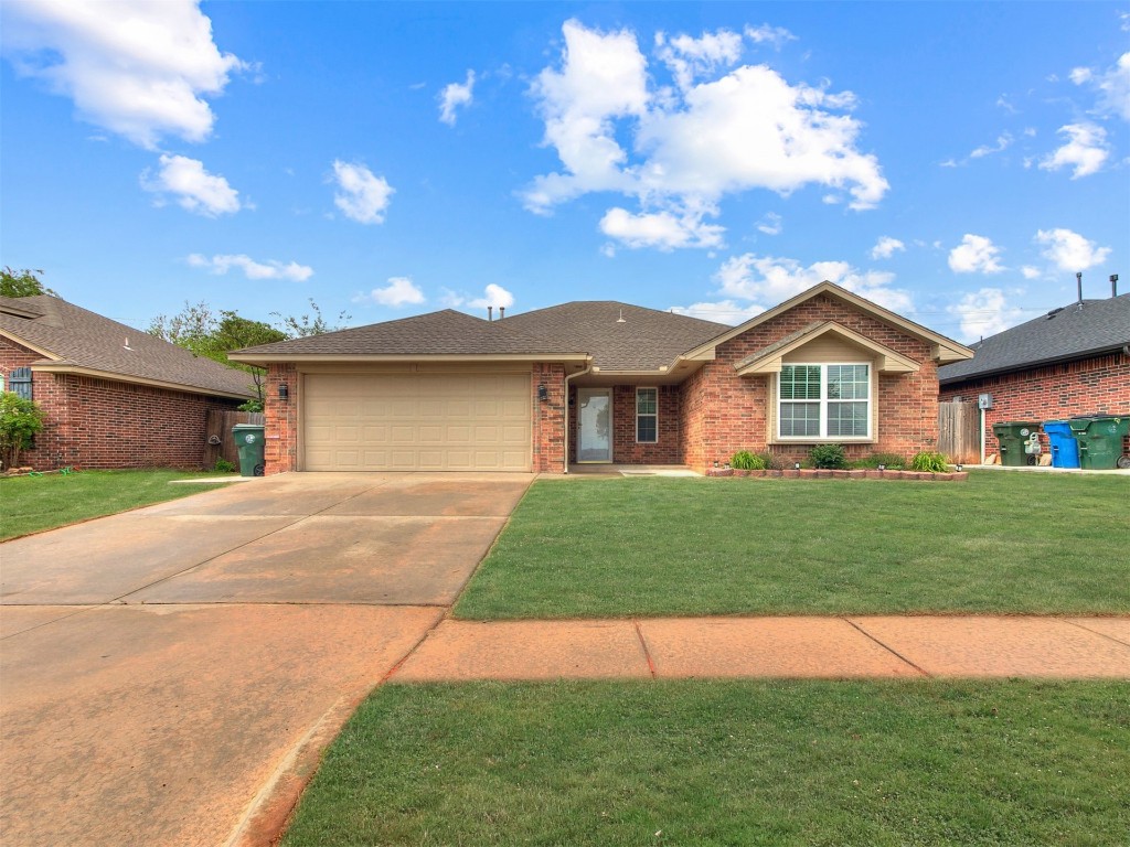 9413 Apple Drive, Midwest City, OK 73130 single story home featuring a garage and a front yard