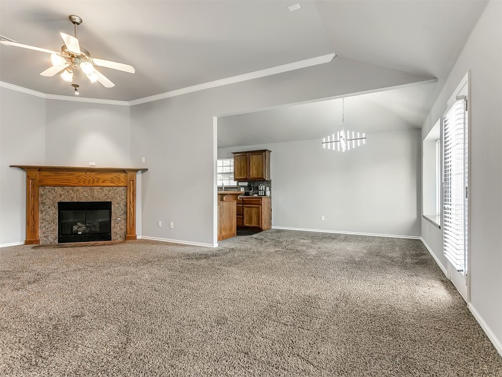 9413 Apple Drive, Midwest City, OK 73130 carpeted spare room featuring vaulted ceiling and ceiling fan